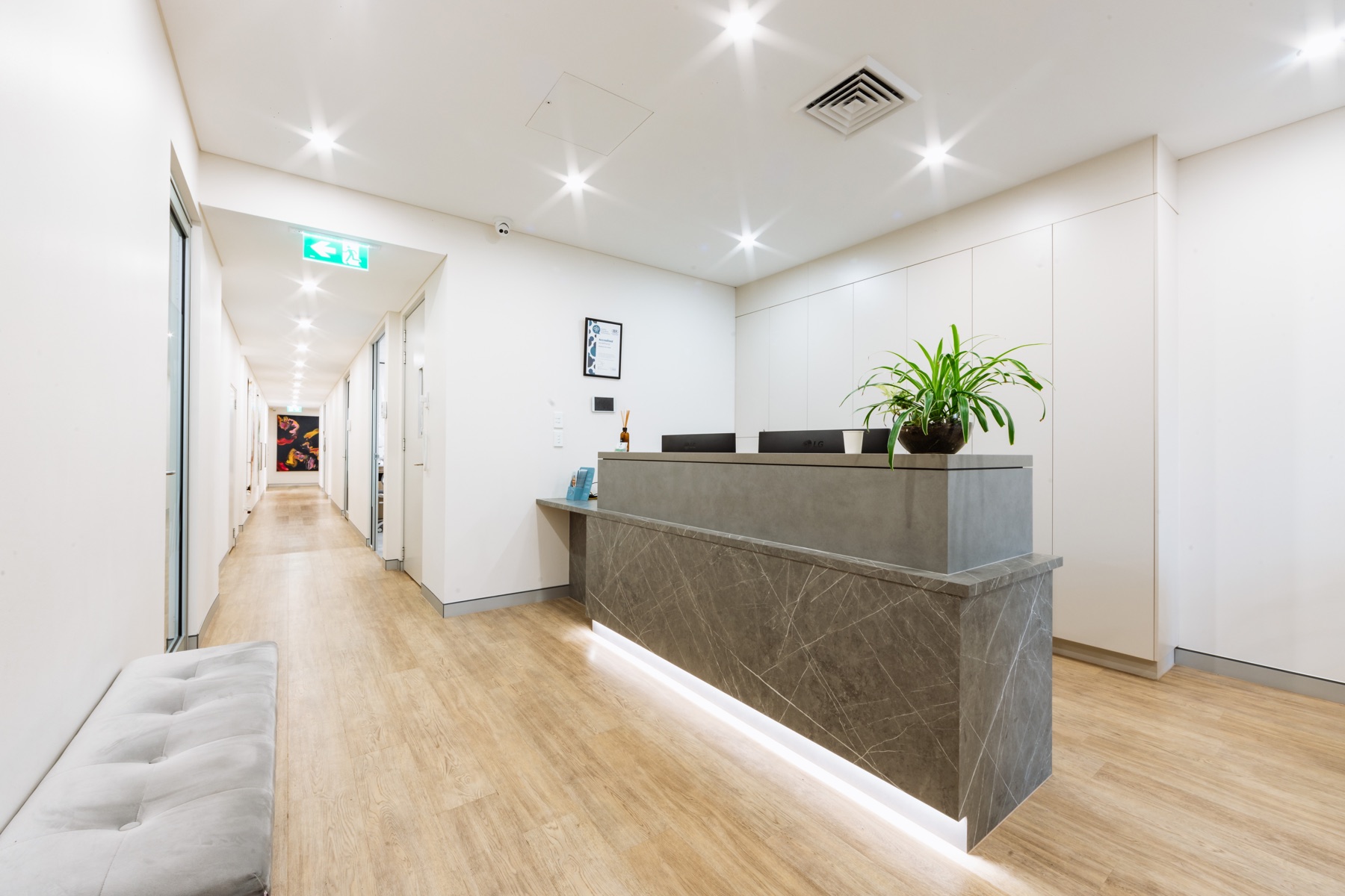 The reception and artwork-lined hallway at Newtown Elite Dental